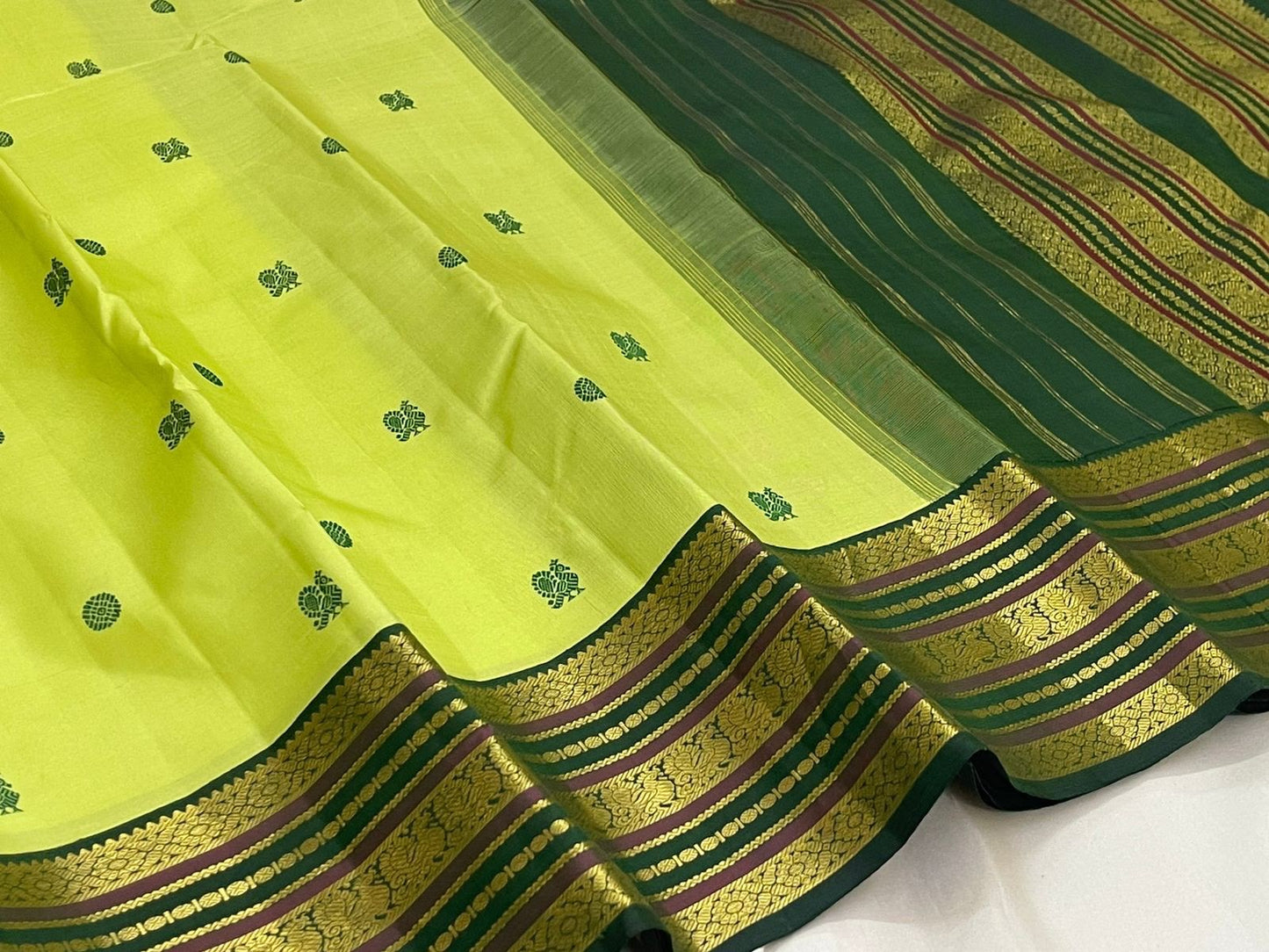 Close-up of lime green silk body with deep green Silk Thread Kamalam and Mayil Butta — Kanjeevaram Varisaipet