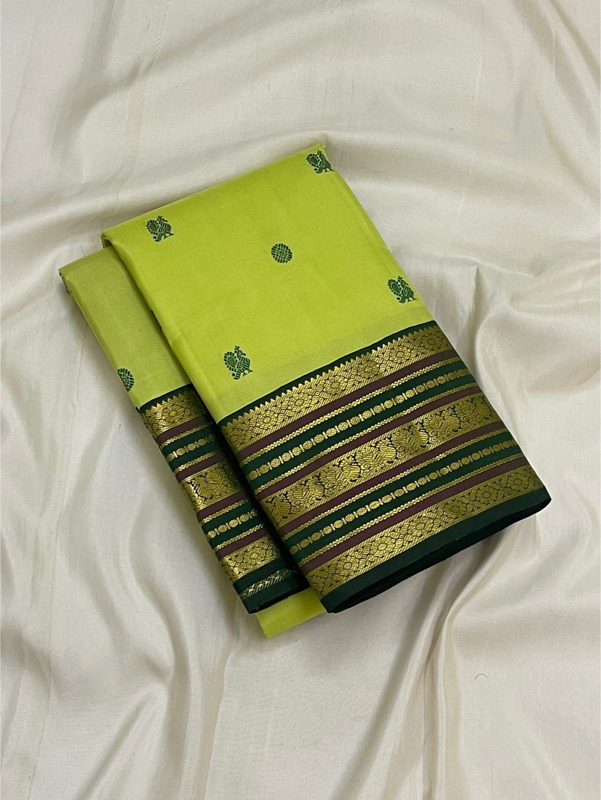 Full folded view of lime green Kanjeevaram Varisaipet saree showing Silk Thread Butta body and dark green border