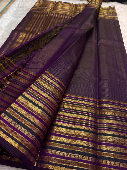 Close view of the deep purple silk body showing Varisaipet horizontal gold zari bands running continuously across the full fabric