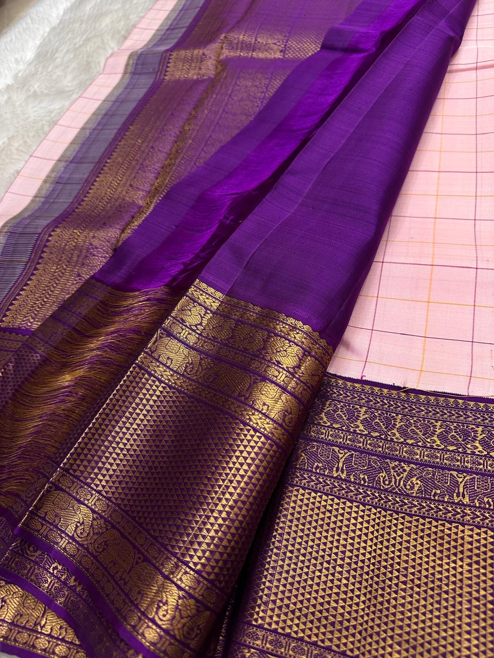 Handwoven Kancheepuram Zari Kattam saree in self-colour radiant pink with Kamalam Butta and deep purple heavy gold zari border, full folded view