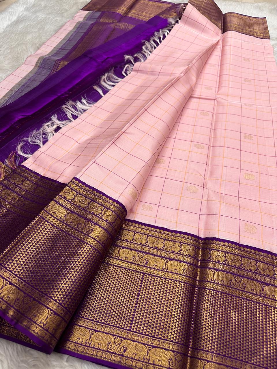 Close-up of radiant pink silk body with fine gold Zari Kattam grid and Floral Butta — Kanjeevaram saree