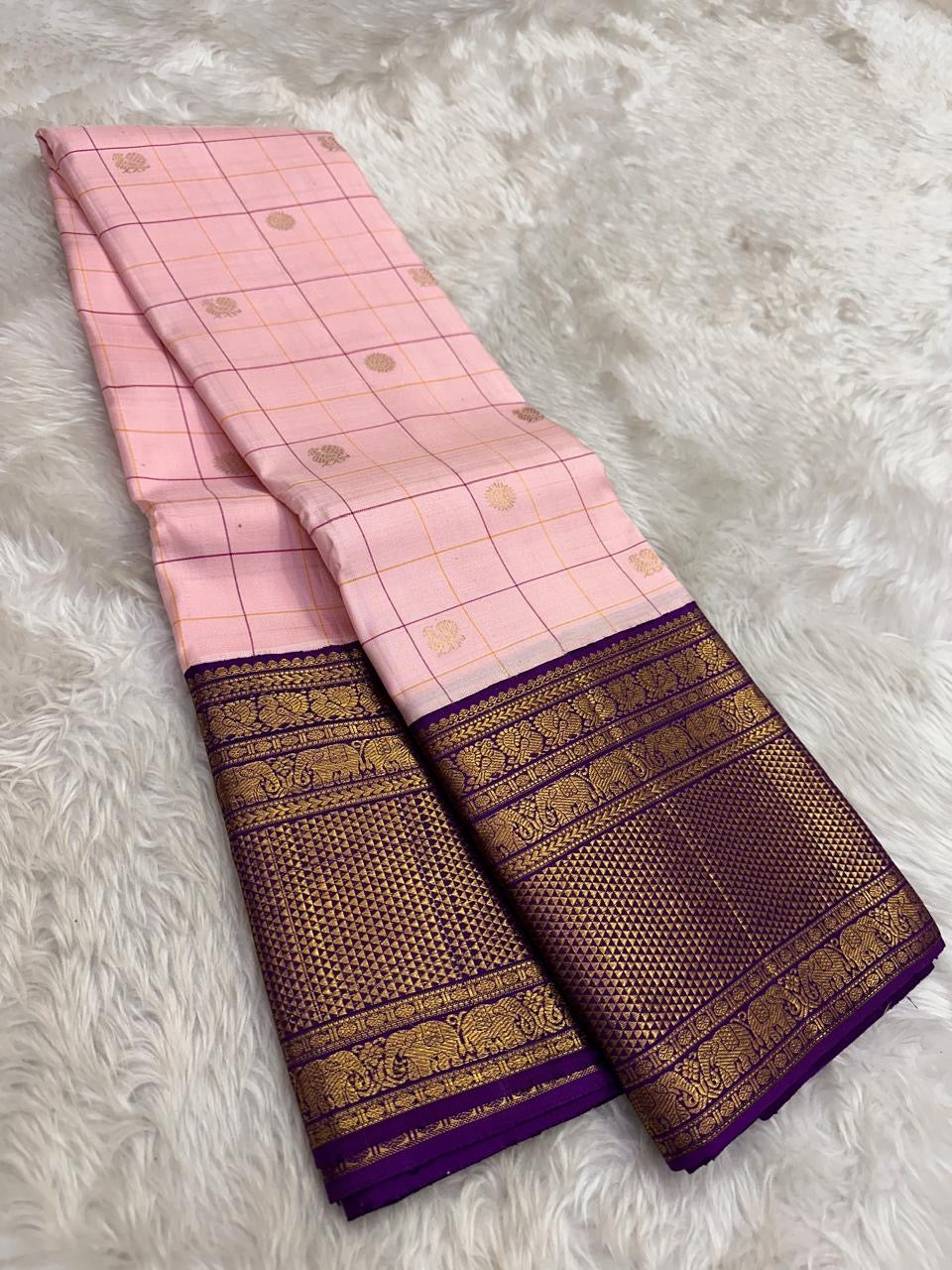 Full folded view of radiant pink Kanjeevaram Zari Kattam saree showing Floral Butta body and deep purple border
