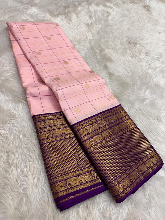 Full folded view of radiant pink Kanjeevaram Zari Kattam saree showing Floral Butta body and deep purple border