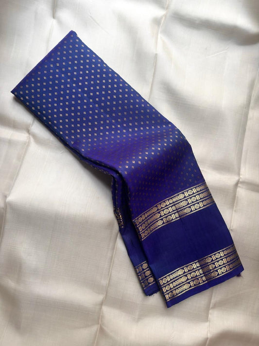 Handwoven Kanjeevaram Rettapet saree in royal blue with scattered Floral Butta and antique gold geometric zari border, full folded view
