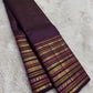 Handwoven pure silk Kanjeevaram saree in deep purple with full body Varisaipet in gold zari — chevron, geometric, and floral bands end to end — Idam Living
