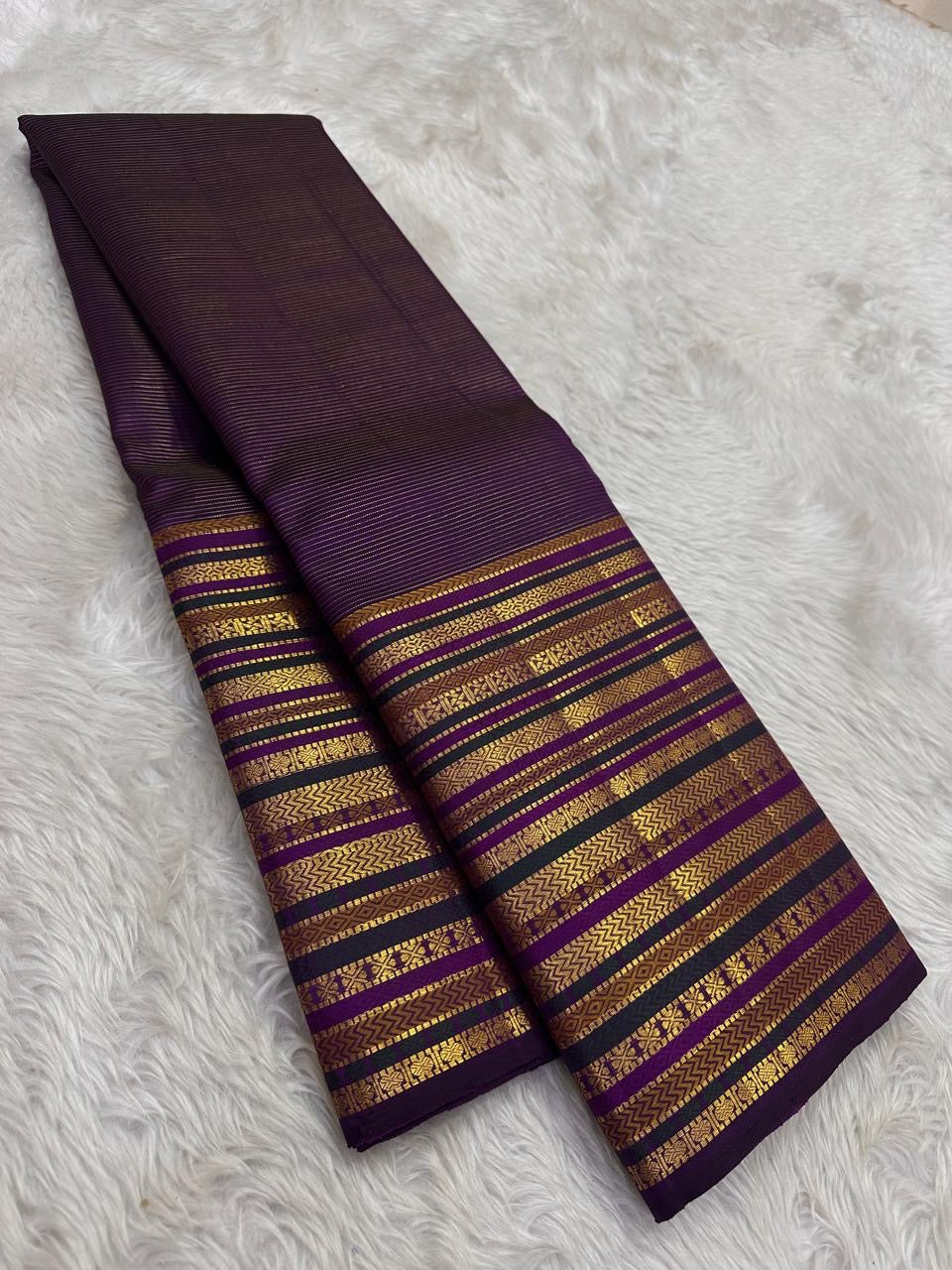 Handwoven pure silk Kanjeevaram saree in deep purple with full body Varisaipet in gold zari — chevron, geometric, and floral bands end to end — Idam Living