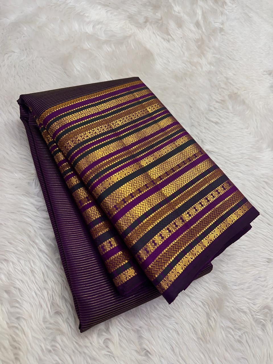 Detail of the Varisaipet geometric diamond and floral band structure in gold zari on the deep purple Kanjeevaram saree