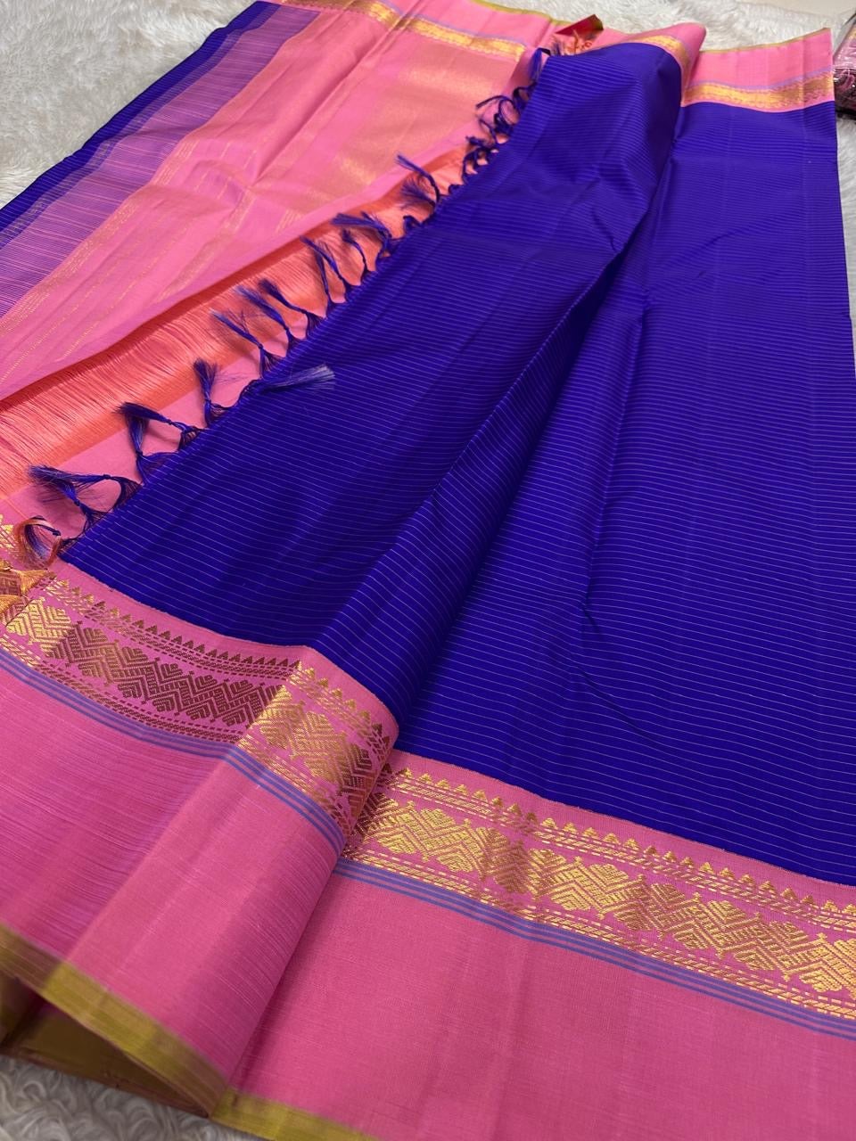 Pallu detail of royal blue and radiant pink pure silk Kanjeevaram saree showing antique gold zari geometric motifs in Kaal Irangiya border