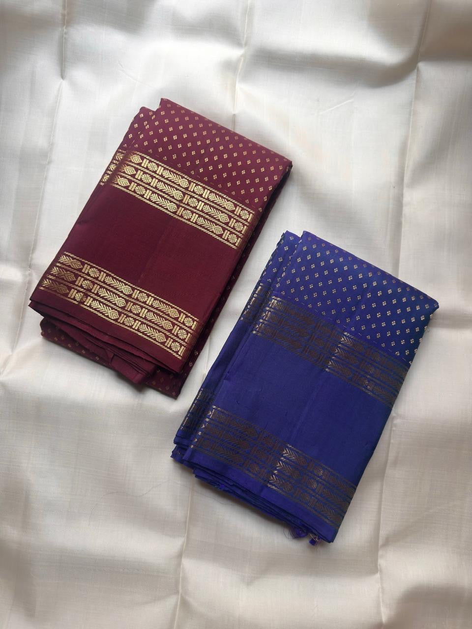 Close-up of deep burgundy silk body with diagonal repeating Floral Butta in antique gold zari — Kanjipuram Rettapet