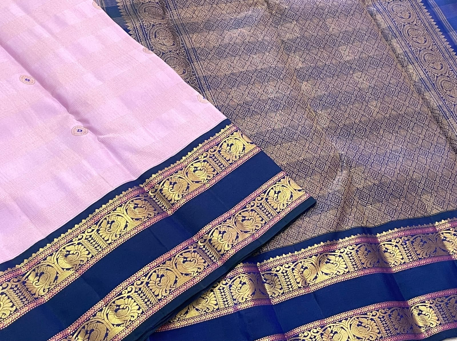 Handwoven Kanjipuram Butta saree in soft lavender with Meenakari Kamalam Butta and deep navy Rettapet Mayil gold zari border, full folded view