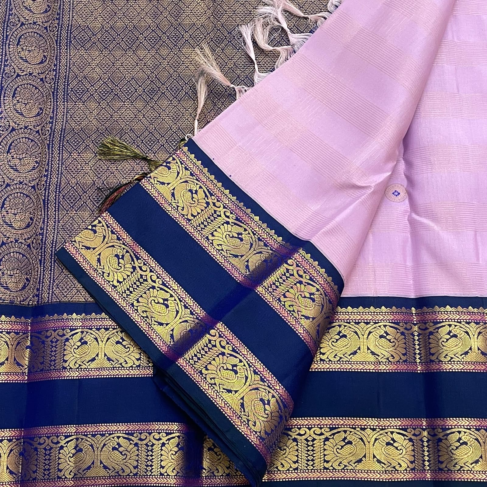 Antique gold Mayil Butta peacock and floral scroll pallu on deep navy Rettapet — Kanjipuram Butta lavender saree