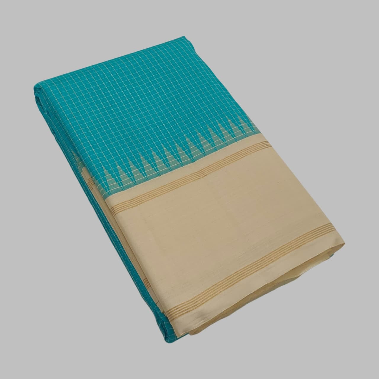 Detail of the Kanchi Kattam grid in the peacock blue body — intersecting silk threads forming a structured checkered pattern in zari