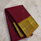 Folded view of the handwoven arakku red Kanjipuram lightweight saree showing Nakshatra Butta body and antique gold Varisaipet border