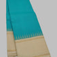 Close view of the peacock blue silk body showing the Kanchi Kattam intersecting silk thread grid in zari across the full length