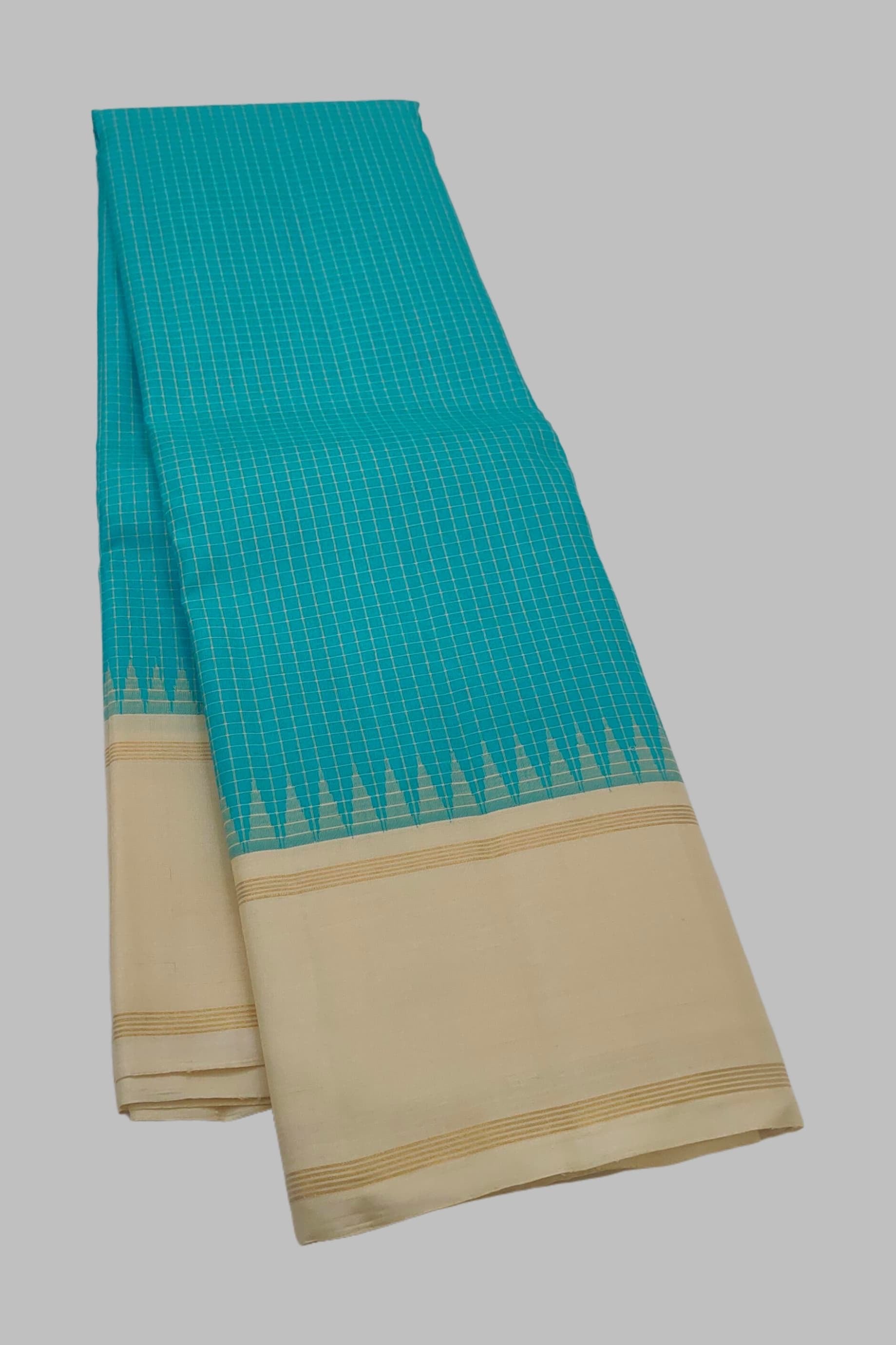 Close view of the peacock blue silk body showing the Kanchi Kattam intersecting silk thread grid in zari across the full length