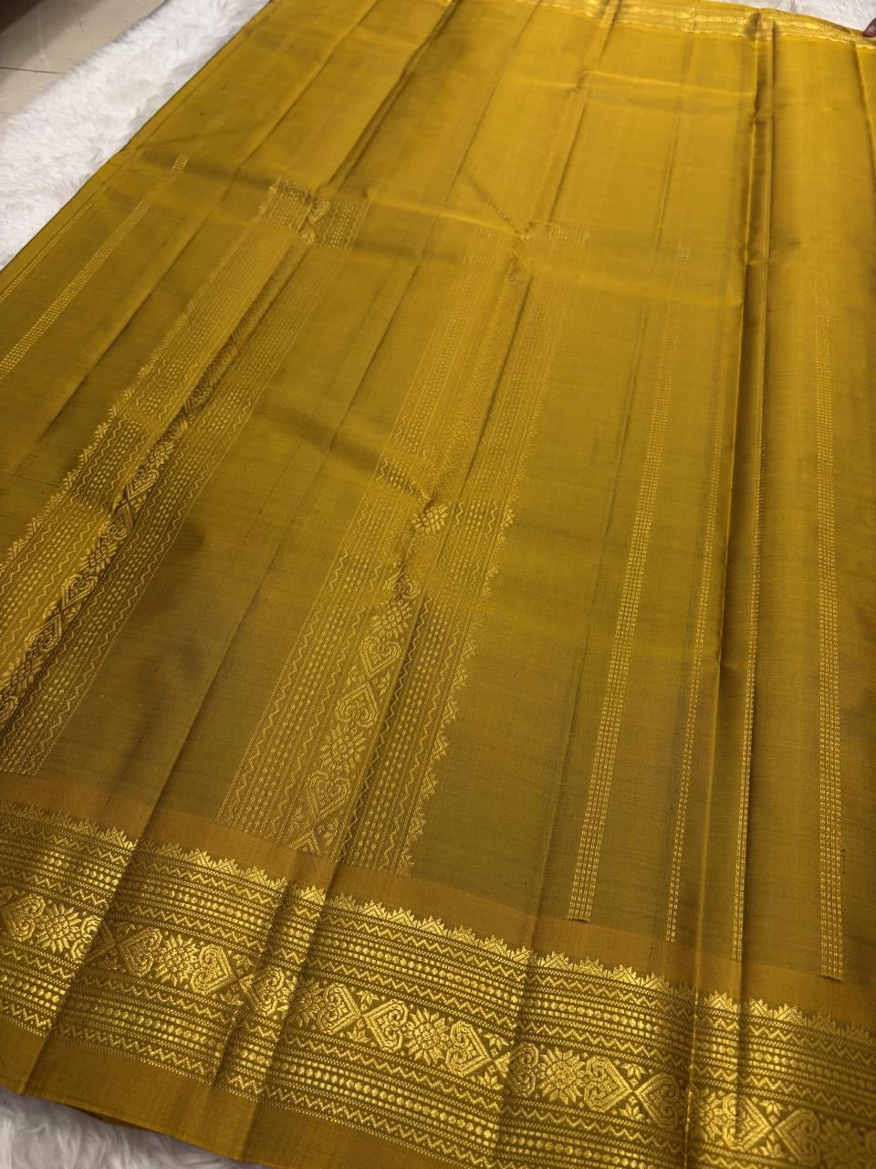 Close view of the arakku red silk body showing Nakshatra Butta star motifs scattered in gold zari across the full length