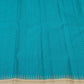 Border detail showing the Pillayar Reku in pale gold zari at the peacock blue to ivory transition on the Kanjipuram saree