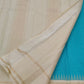 Folded view of the handwoven peacock blue Kanjipuram silk saree showing Kanchi Kattam body and ivory Pillayar Reku border