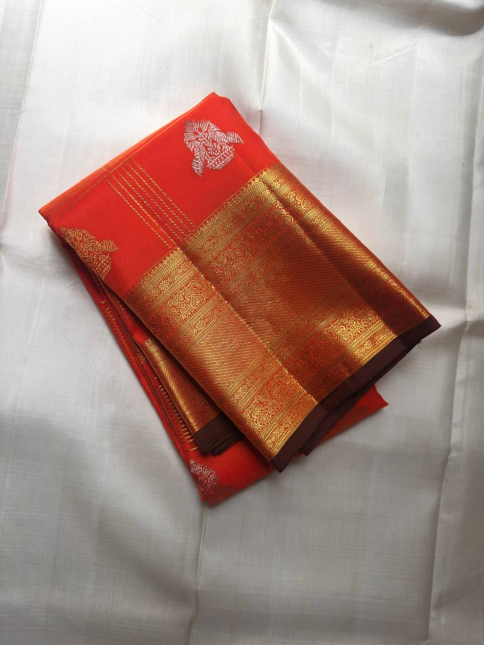 Close-up of shot coral-to-magenta silk body with Zari Kattam gold grid and Maanga Butta in gold and silver — KanchiPattu Veldhari