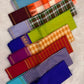 Close-up of Vazhaipu Veldhari stripe body showing horizontal orange and arakku red silk bands with fine chain-stitch zari detailing on pure silk Kanjipuram saree