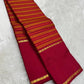 Pallu detail of orange and arakku red pure silk Kanjipuram saree showing arakku red Korvai border with antique gold zari band