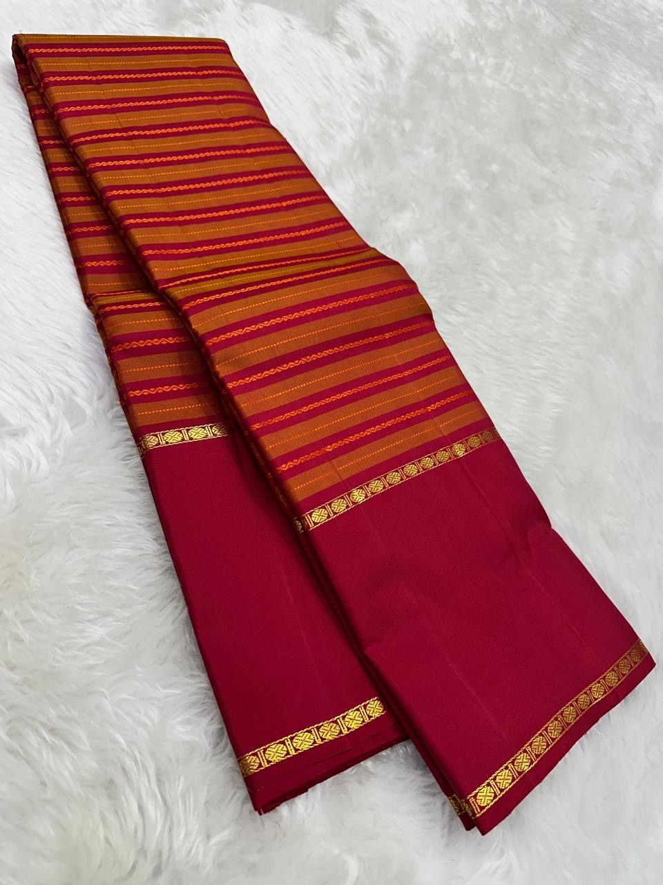 Pallu detail of orange and arakku red pure silk Kanjipuram saree showing arakku red Korvai border with antique gold zari band