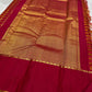 Folded view of orange and arakku red handwoven pure silk Kanjipuram saree with Vazhaipu Veldhari stripe body and Korvai border