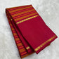 Fine chain-stitch zari detailing on Vazhaipu Veldhari horizontal stripe body of handwoven orange and arakku red Kanjipuram saree
