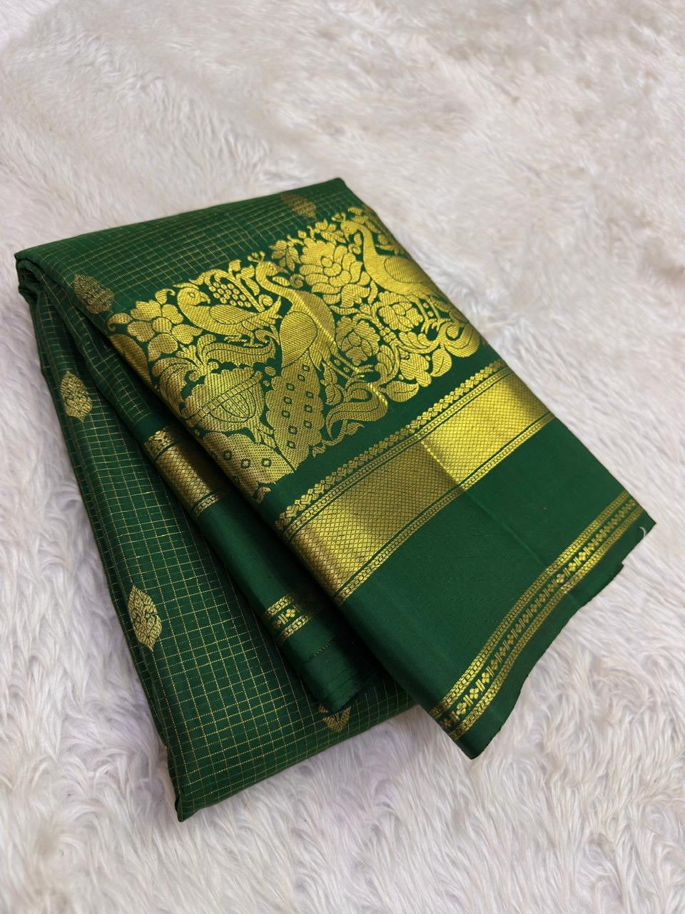 Grand Mayil Butta peacock figural in heavy gold zari on forest green border — Kanjivaram Zari Kattam saree detail