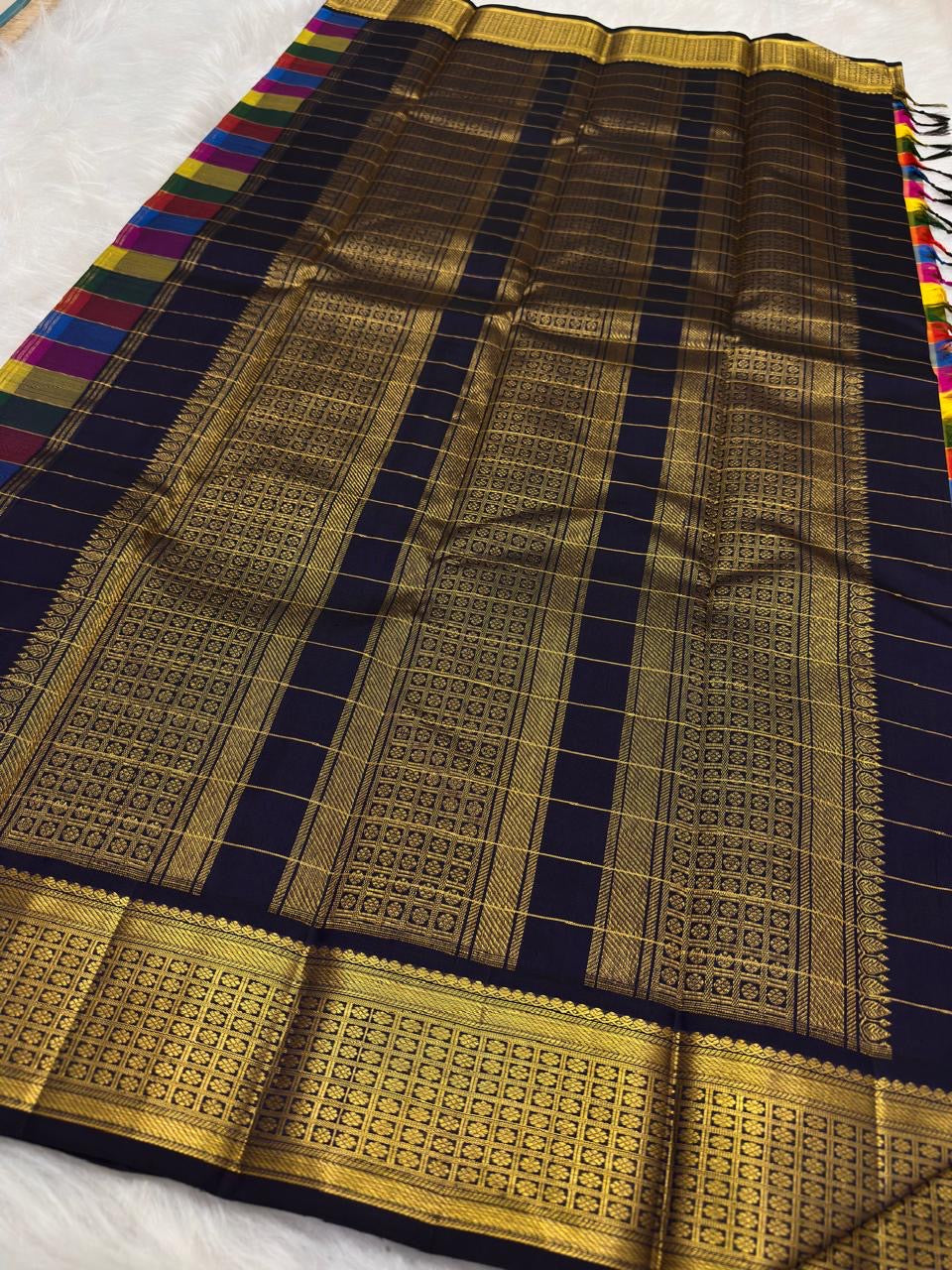 Full folded view of multicolour Paalum Pazhamum Kanjivaram saree showing check body and deep navy border contrast