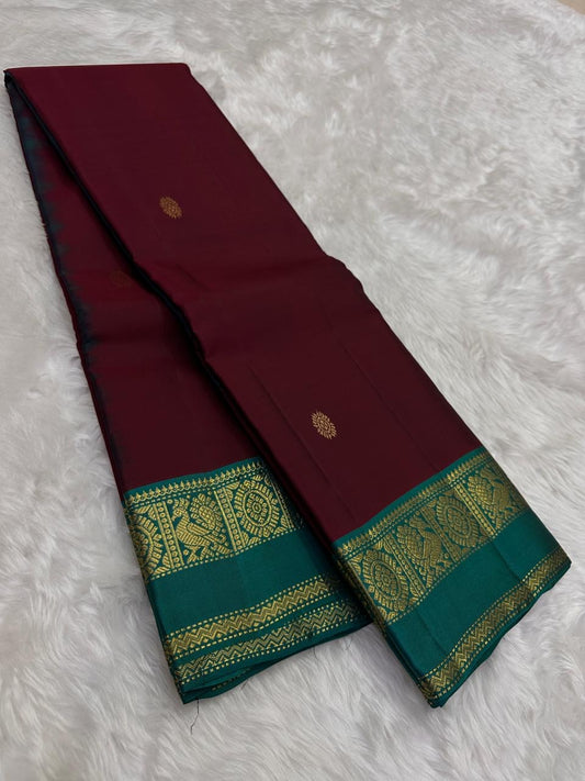 Close view of the arakku red silk body showing scattered Kamalam Butta lotus motifs in gold zari