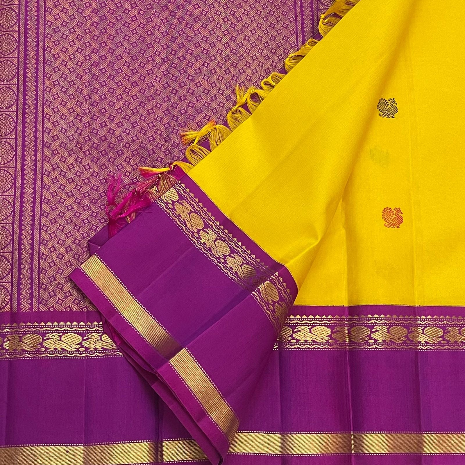 Canary yellow and violet Kancheepuram pure silk saree with Rettapet border and silk thread buttas — folded view