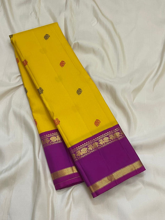 Multicolour silk thread Kamalam and Pavun buttas on canary yellow pure silk Kancheepuram Rettapet saree — body close-up