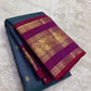 Close-up of deep teal Zari Kattam silk body showing fine intersecting gold zari grid and scattered gold buttas on pure silk Kanjivaram saree