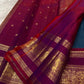 Folded view of teal and arakku red handwoven pure silk Kanjivaram saree with Zari Kattam body and Rettapet elephant border