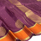Burnished orange border on a muted aubergine Kancheepuram saree