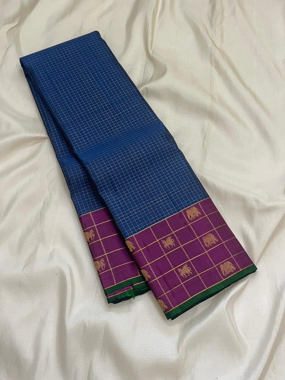 Kathiripoo purple border with elephant and flying horse zari motifs on a Kanjivaram saree