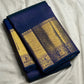 Navy blue Kanchipuram saree body with peacock blue-green shot colour and luminous zari grid — close-up