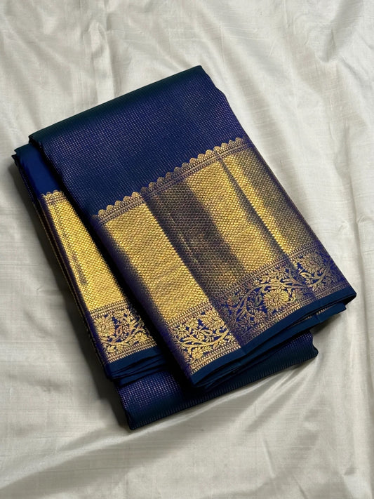 Navy blue Kanchipuram saree body with peacock blue-green shot colour and luminous zari grid — close-up