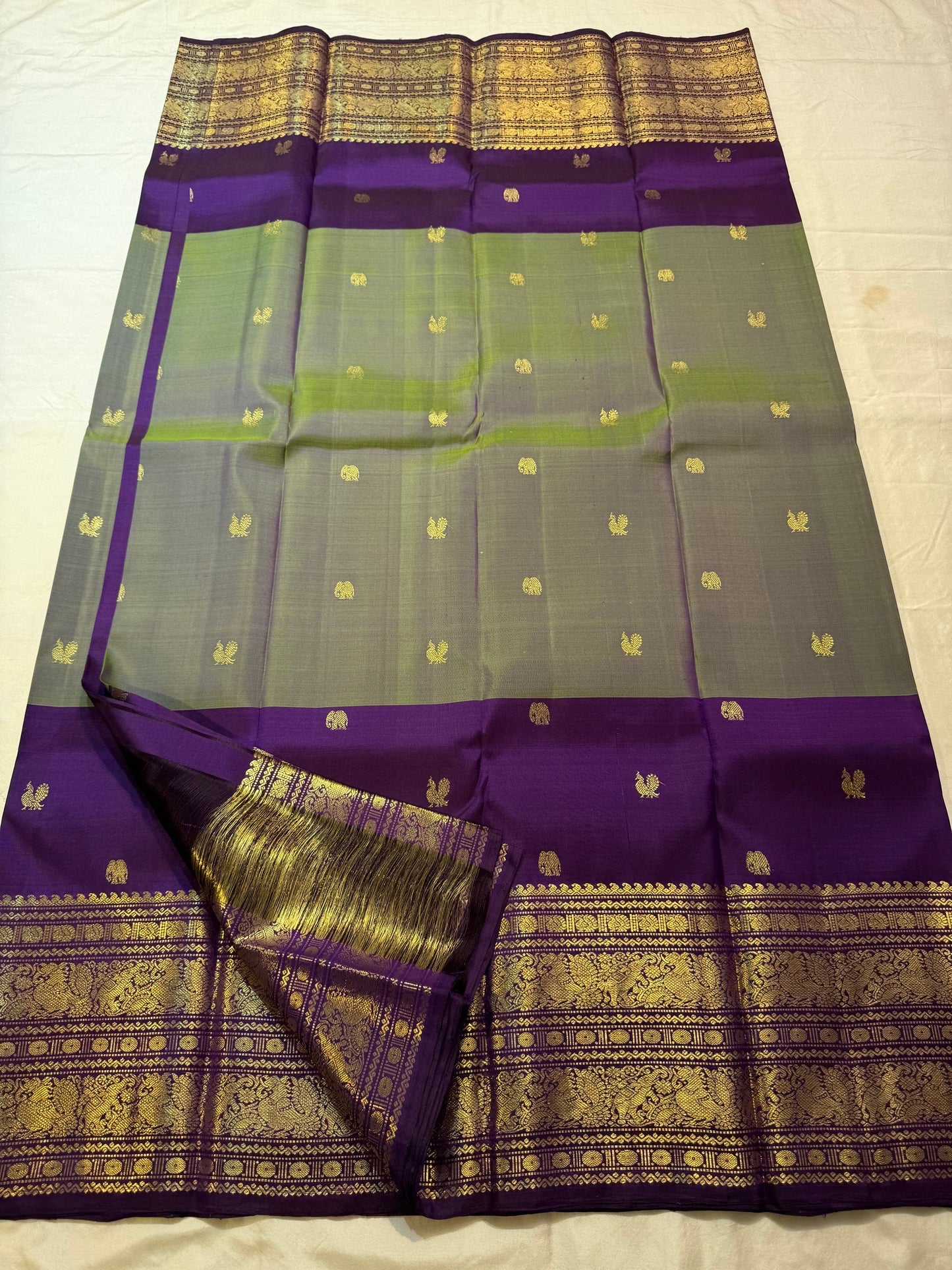 Deep purple Korvai border with structural loom join on olive green Kanchipuram silk saree