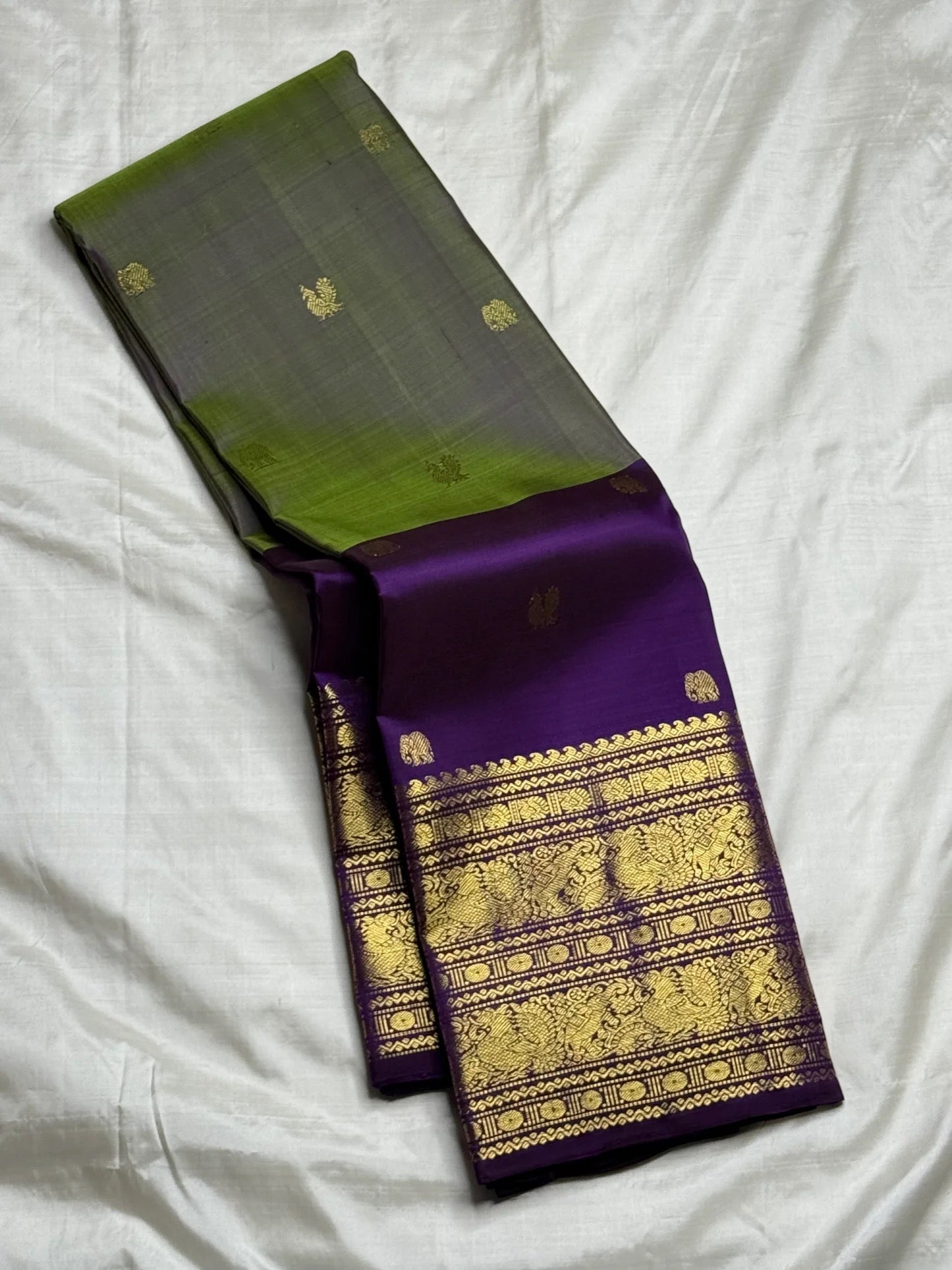 Deep purple Kanchipuram pallu with wide dense gold zari temple motifs — full spread