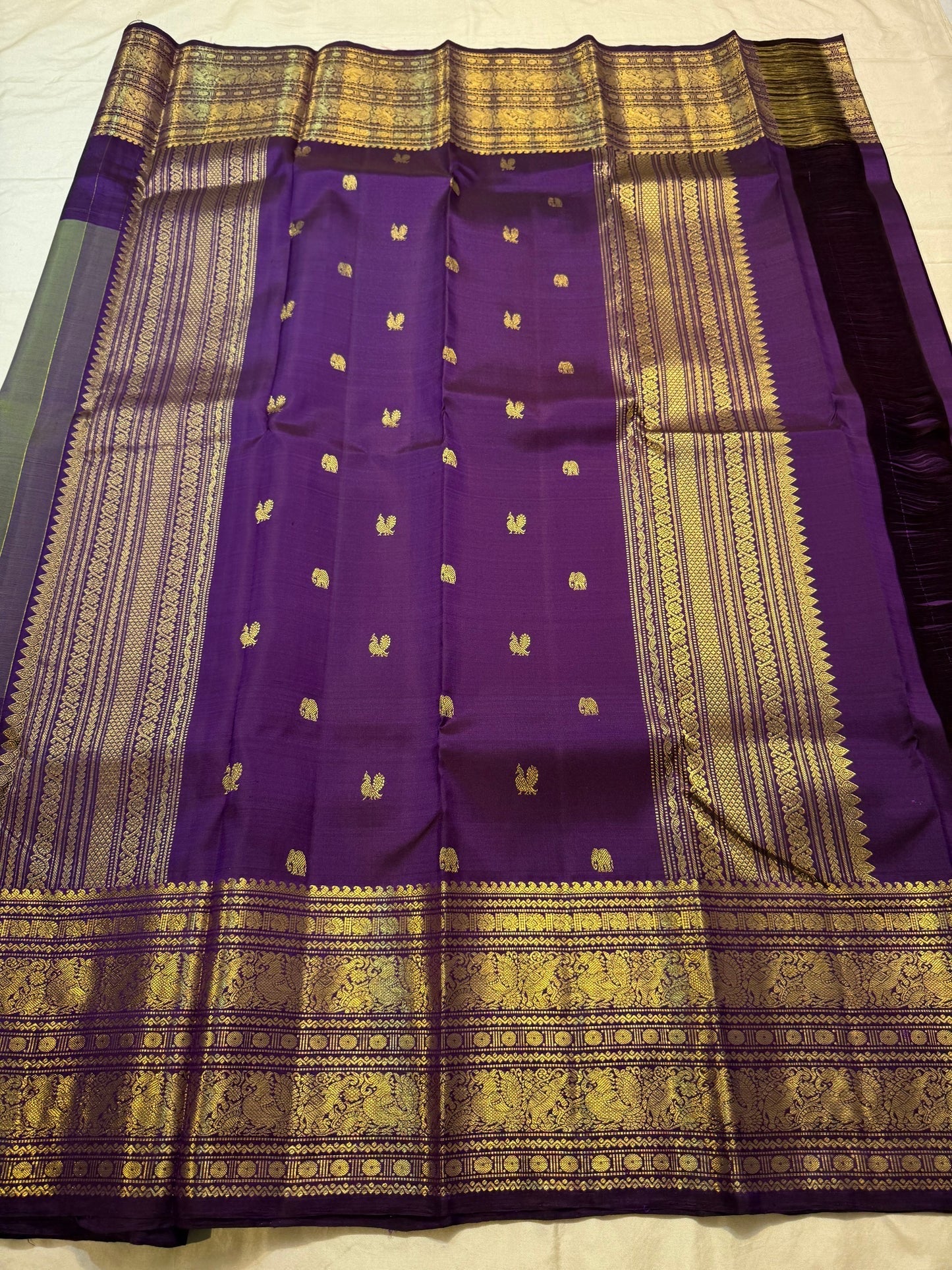 Olive green Kanchipuram saree body with scattered gold zari bird butta — close-up