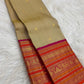 Olive Gold Kanchipuram silk body with small spaced gold zari buttas and colourful Varisaipet border.