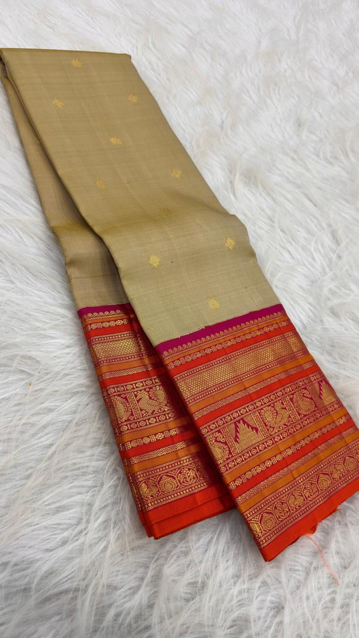 Olive Gold Kanchipuram silk body with small spaced gold zari buttas and colourful Varisaipet border.