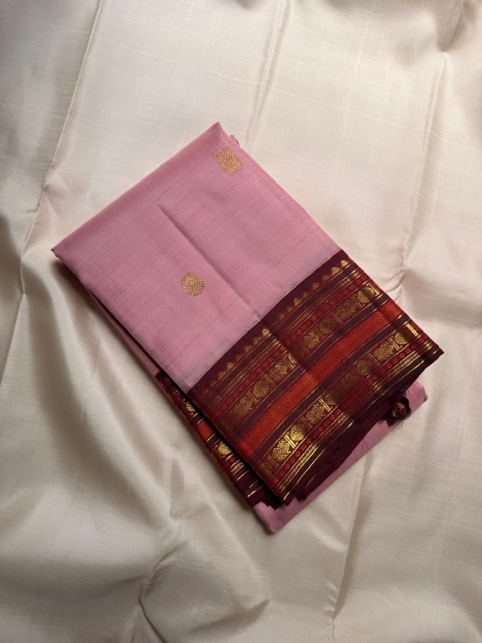 Mellow pink Kanchipuram saree with deep Arakku and gold zari