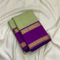 Close-up of pistachio green mulberry silk body with gold zari Kamalam butta on Kanjivaram saree