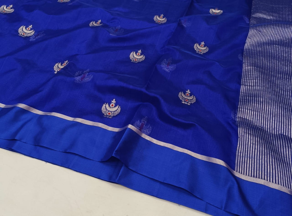 Model wearing Royal Blue Pattu Silk Chanderi saree with silver woven motifs, slim border and striped metallic pallu