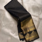 Pure Kanchipuram silk saree folded showing wide gold zari border with black edge and gold woven motif band