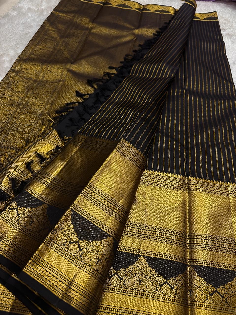 Pure Kanchipuram silk saree border closeup with wide gold zari border, black panel with gold woven motifs, shipped from New Jersey USA