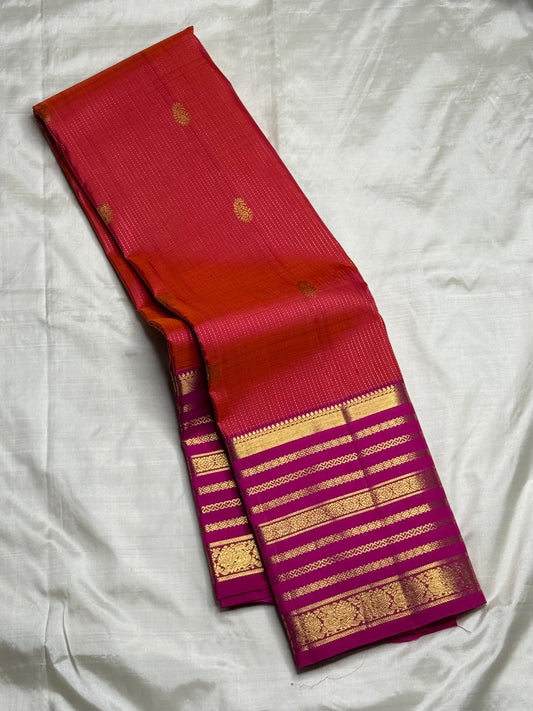 Red and magenta Kanchipuram Vairaoosi saree folded flat — full length view